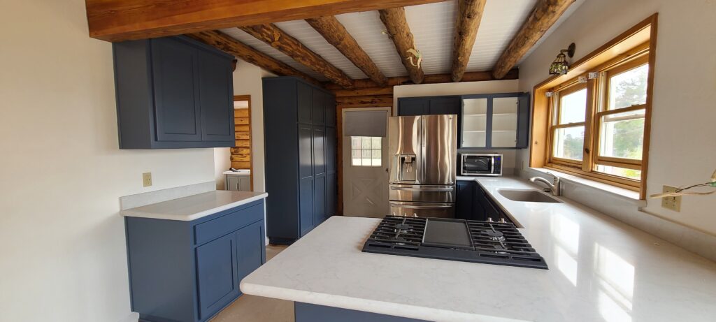 Interior painting project by Bruce Owens Painting in a kitchen with exposed wood beams